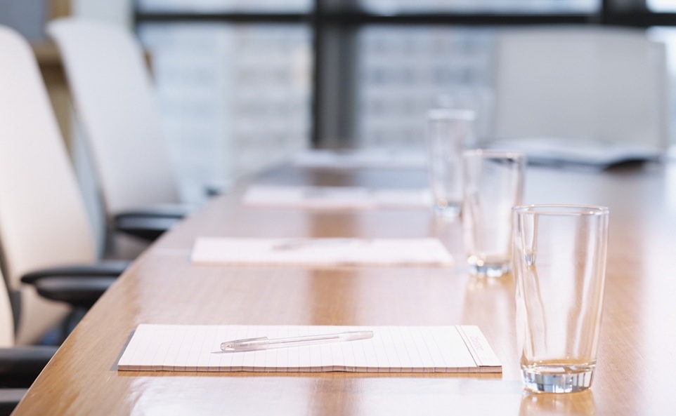 boardroom table with notepads
